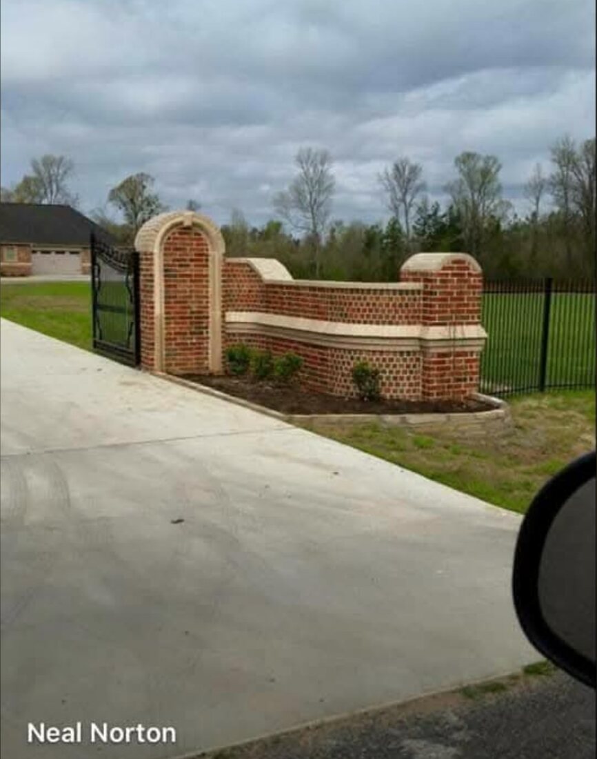 Decorative curved brick wall and gate columns